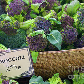 Basket of purple and green broccoli by Bruce Block