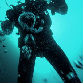 Bubbles surrounding a scuba diver underwater by Sami Sarkis Photography