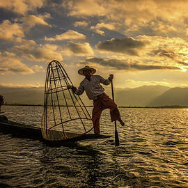 Burmese fishermen on bamboo boats at sunrise by Miroslav Liska