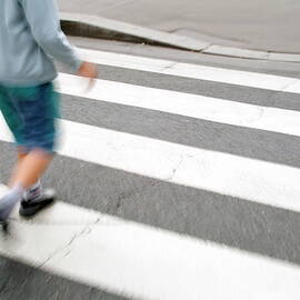 Children walking across a zebra crossing on a city street by Sami Sarkis Photography