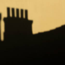Chimneys silhouetted against the evening sky by Sami Sarkis Photography