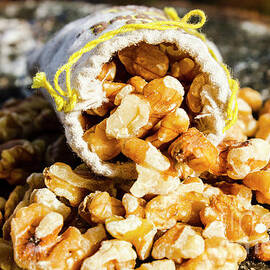 Closeup Of Walnuts Spilling From Small Bag by Jorgo Photography
