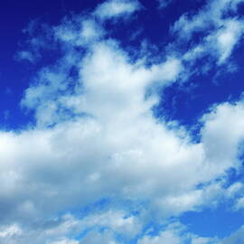 Clouds in a beautiful blue sky by Sami Sarkis Photography