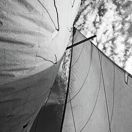 Cloudy sky seen through billowing white sails by Sami Sarkis Photography