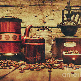 Coffee bean grinder beside old pot by Jorgo Photography