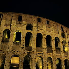 Colosseum illuminated at night by Sami Sarkis Photography