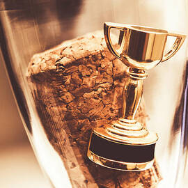 Cork and trophy floating in champagne flute by Jorgo Photography