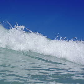 Crashing foamy waves in the blue ocean waters by Sami Sarkis Photography