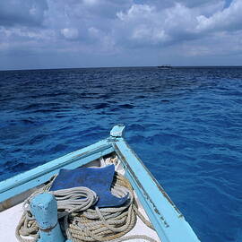 Deck and bow of diver's boat at sea by Sami Sarkis Photography