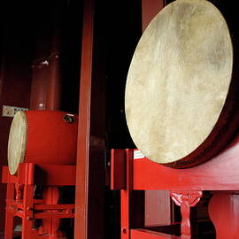 Drums lined up in a row inside a drum tower by Sami Sarkis Photography