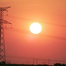 Electrical pylon at silhouetted at sunset by Sami Sarkis Photography