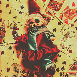 Evil clown doll on playing cards by Jorgo Photography