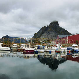 Fishing boats at the port of Reine village on Lofoten islands in Norway by Miroslav Liska