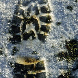 Footprint in snow by Sami Sarkis Photography