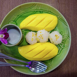Fresh mango and sticky rice served with coconut milk syrup by Miroslav Liska