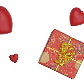 Gift box and heart-shaped objects on white background by Sami Sarkis Photography