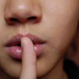 Girl with finger on lips by Sami Sarkis Photography