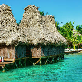 Grass Huts on the water of Ambergris Caye Belize by Waterdancer