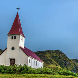 Heavy clouds over the lutheran church in Vik, Iceland by Miroslav Liska
