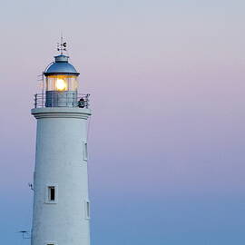 Illuminated lighthouse at sunset by Sami Sarkis Photography