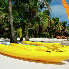 Kayaks on the beach of Ambergris Caye Belize by Waterdancer