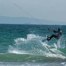 Kite surfer jumping over a wave by Sami Sarkis Photography