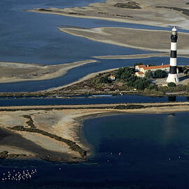 La Gacholle Lighthouse surrounded with blue sea in Camargue by Sami Sarkis Photography