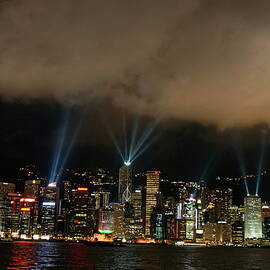 Laser show over city at night by Sami Sarkis Photography