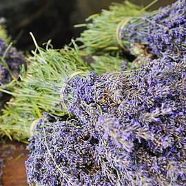 Lavender bouquets on table by Sami Sarkis Photography