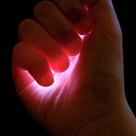 Light captured in child's hand by Sami Sarkis Photography