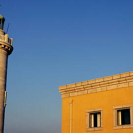 Lighthouse and yellow building at the entrance of the port of Marseille by Sami Sarkis Photography