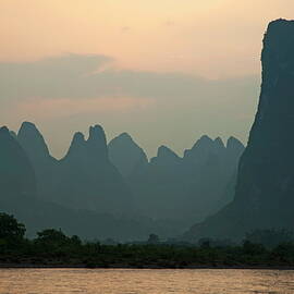 Looking across the Li Jiang River at the limestone mountain peaks between Xinping and Yangshuo by Sami Sarkis Photography