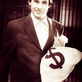 Male Banker Holding Dollar Sign Money Bags by Jorgo Photography