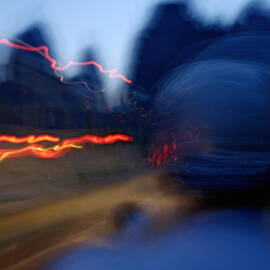 Man driving a motorbike at dusk on a country road among the limestone peaks by Sami Sarkis Photography