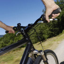 Man speeding on mountain bike  by Sami Sarkis Photography