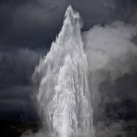 Old faithful with ominous skies by Bruce Block