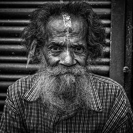 Old man sitting in the street of Kathmandu, Nepal by Miroslav Liska