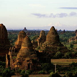 Pagodas scattered throughout the countryside at sunrise by Sami Sarkis Photography