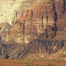 Person riding a motorbike through the Wadi Rum desert in Jordan by Sami Sarkis Photography
