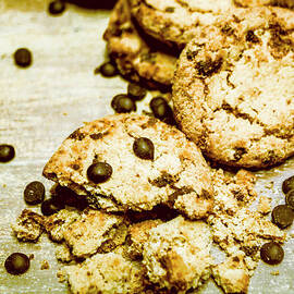 Pile of Crumbled Chocolate Chip Cookies on Table by Jorgo Photography