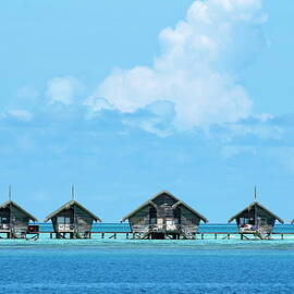 Resort bungalows over sea by Sami Sarkis Photography