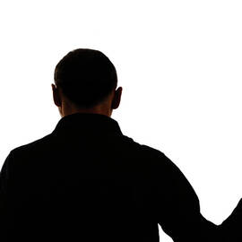 Silhouette of man holding rose by Sami Sarkis Photography