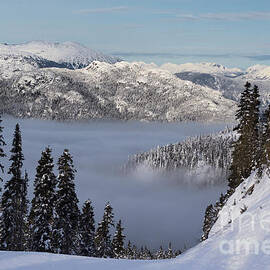 Skiing above the clouds by Bruce Block