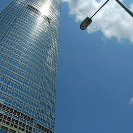 Skyscraper and street lamp with cloudy sky in Hong Kong by Sami Sarkis Photography