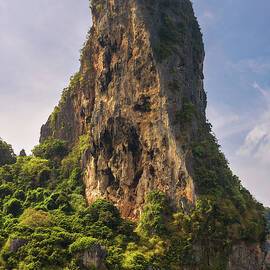 Small boat under huge cliff of Phi Phi islands  by Miroslav Liska