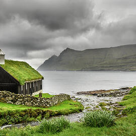 Small village church under heavy clouds by Miroslav Liska