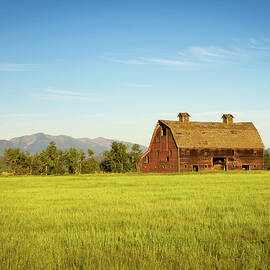 Summer sunset with an old barn in rural Montana by Miroslav Liska