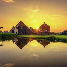 Sunset above farm houses and windmills of Zaanse Schans in the Netherlands by Miroslav Liska
