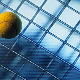 Tennis ball on TV screen displaying racket's wire mesh by Sami Sarkis Photography