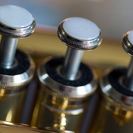 Three musical keys on a shiny trumpet by Sami Sarkis Photography